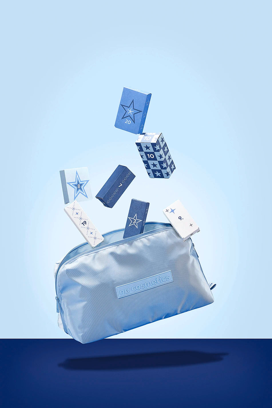 Nø Cosmetics Adventskalender Tasche mit geschlossenen Türchen auf blauem Hintergrund. 